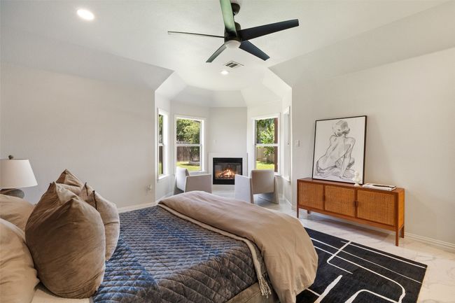 Bedroom with a glass covered fireplace, recessed lighting, marble finish flooring, and a ceiling fan | Image 20