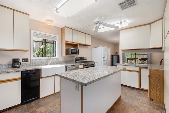 Kitchen with updated countertops | Image 8