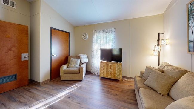 Living area with wood finished floors and lofted ceiling | Image 40