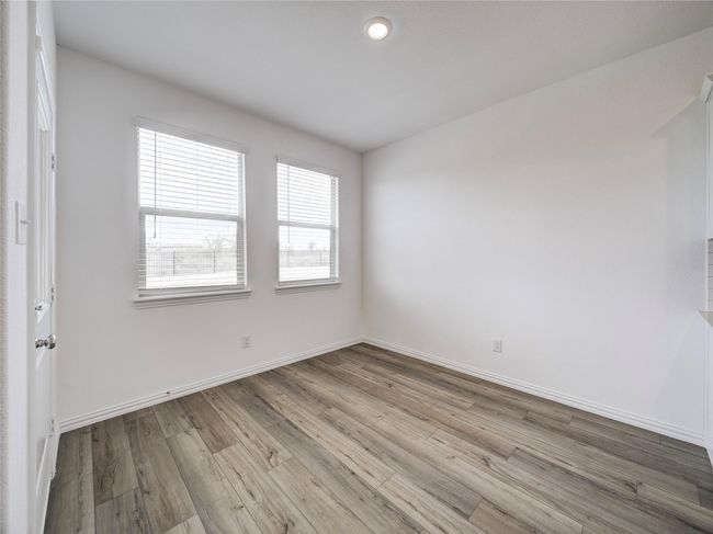 Spare room featuring healthy amount of natural light, wood finished floors, baseboards, and recessed lighting | Image 19