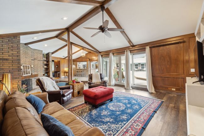 Living Room Features Sliding Glass Doors and Pool Views | Image 10