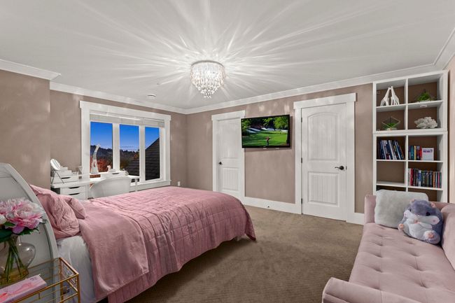 Carpeted bedroom with baseboards, crown molding, and a notable chandelier | Image 28