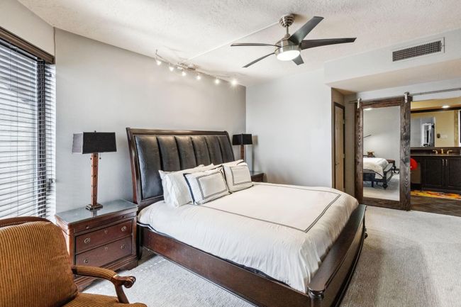 Primary bedroom is oversized and well lit with a nice seating area. | Image 24