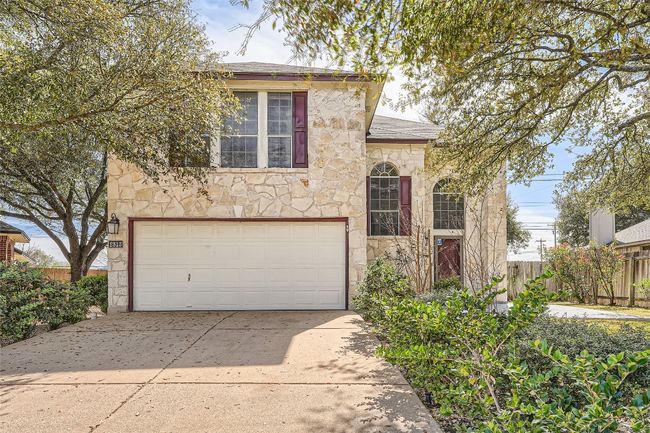 Beautiful mature trees and landscaping adorn the front of the home. | Image 10