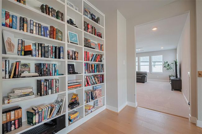 Built-in bookshelves make a smart use of space in upstairs hallway just outside the game room. | Image 37