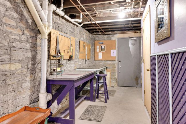 In the basement, this craft / work space area is shared among the residents. | Image 21