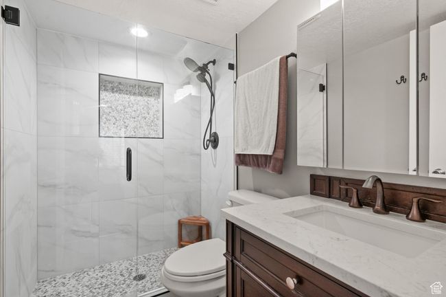 Bathroom featuring a shower stall and vanity | Image 11