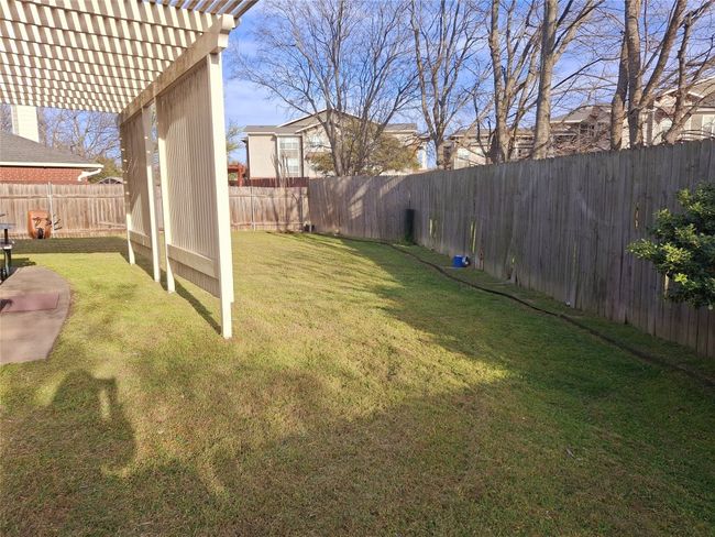 View of yard featuring a fenced backyard and a pergola | Image 5