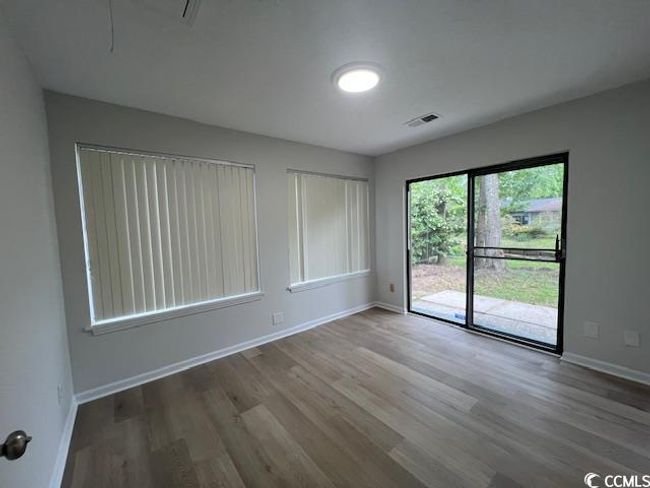 Unfurnished room with baseboards, visible vents, and wood finished floors | Image 36