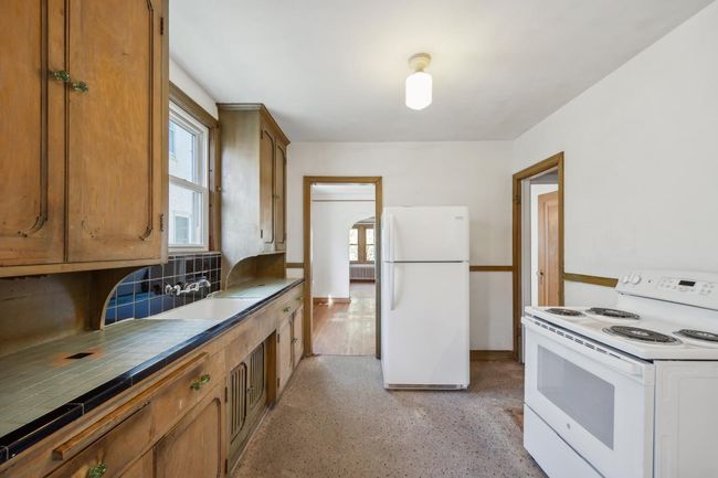 So much potential for this room. You could close off or move doorways, or perhaps open up walls. There are a lot of ways you could remodel this kitchen to make it yours! | Image 16