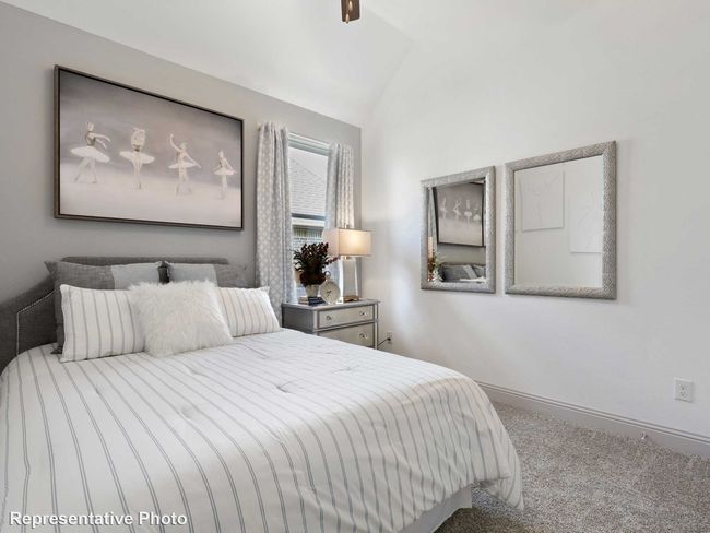 Bedroom with carpet floors, lofted ceiling, and baseboards | Image 11