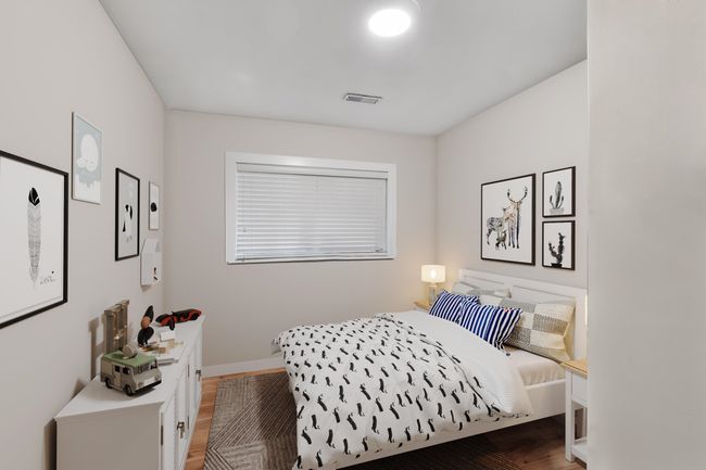 Bedroom featuring wood finished floors, visible vents, and baseboards | Image 7