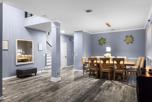 Dining space with crown molding, decorative columns, and dark hardwood / wood-style floors | Image 9