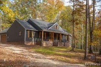 View of front of property with a porch and a garage | Image 1