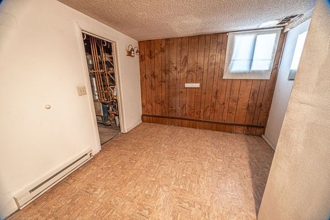 Spare room with a baseboard radiator and a textured ceiling | Image 32