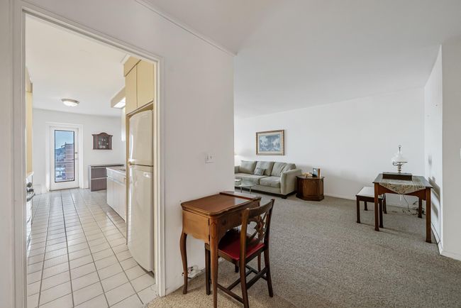 View of kitchen and living room from foyer | Image 7