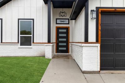 Property entrance with a garage and a yard | Image 3