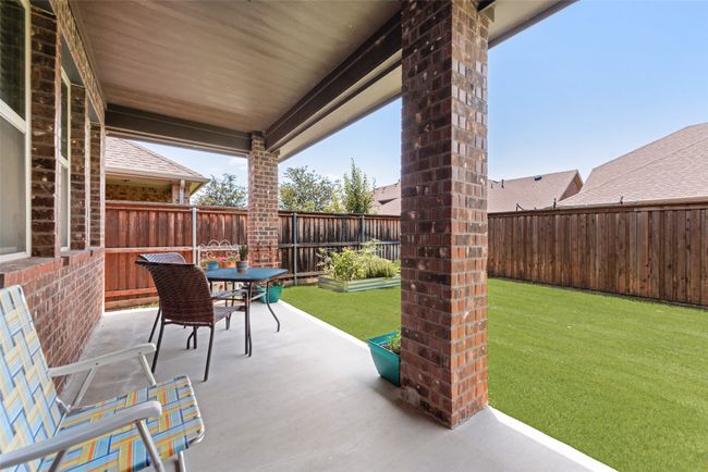 Fenced backyard featuring a patio and outdoor dining area | Image 33