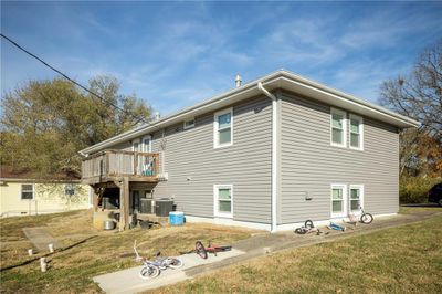 Rear view of property with cooling unit and a lawn | Image 3