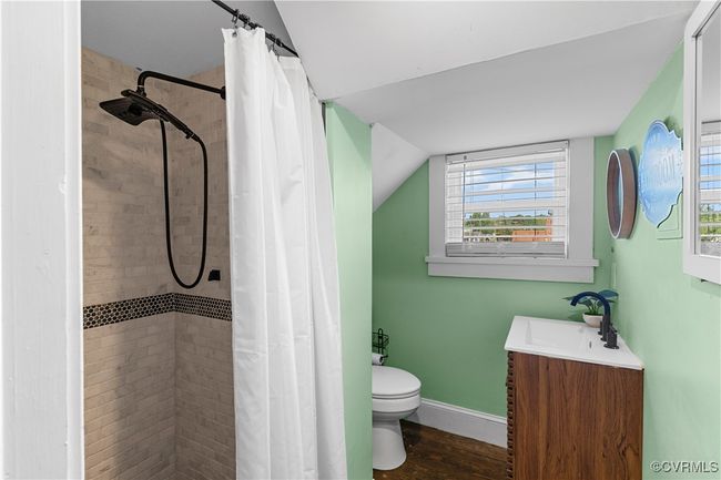 Full bath with a tile shower, toilet, and a healthy amount of sunlight | Image 21