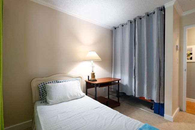 Bedroom featuring a textured ceiling, baseboards, ornamental molding, and carpet flooring | Image 19