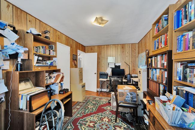 Office featuring wooden walls | Image 12