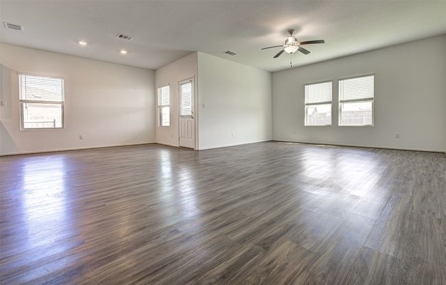 Empty room featuring a ceiling fan, dark wood-style floors, baseboards, and recessed lighting | Image 6
