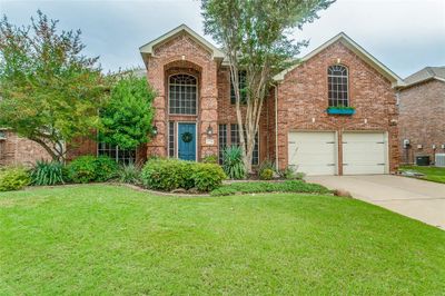 View of property featuring a garage and a front lawn | Image 1