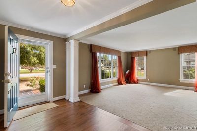 Foyer with crown molding, carpet, and a wealth of natural light | Image 3