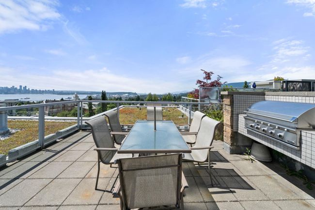 View of patio / terrace with a grill, a water view, and outdoor dining area | Image 26