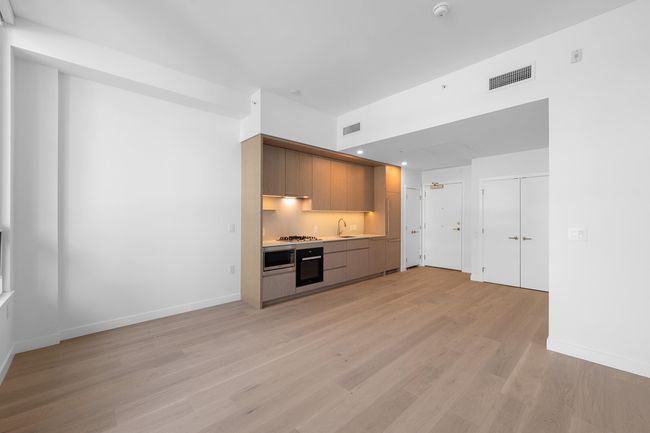 Kitchen with oven, light wood finished floors, modern cabinets, and recessed lighting | Image 5