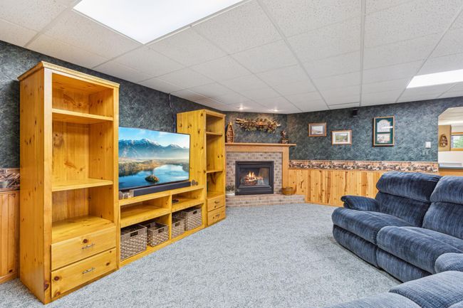 Brick surround gas fireplace is the heart of this large but cozy family room. | Image 23