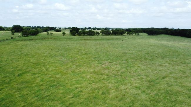 View of green lawn with a view of countryside | Image 4