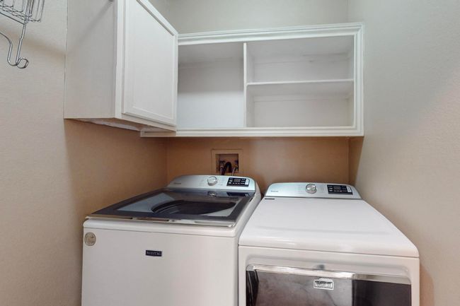 Laundry room featuring independent washer and dryer and cabinet space | Image 36