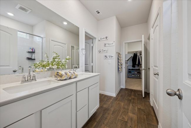 Bathroom featuring wood finished floors, double vanity, recessed lighting, a spacious closet, and an enclosed shower | Image 28