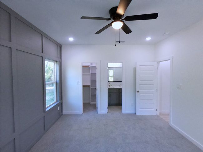Unfurnished bedroom with recessed lighting, a spacious closet, light carpet, and visible vents | Image 7