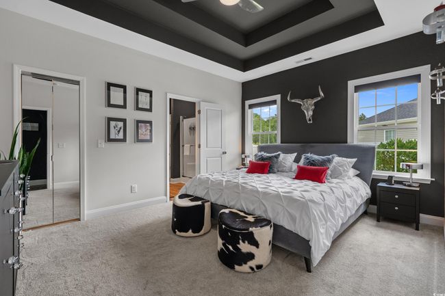 Carpeted bedroom with a tray ceiling and ensuite bathroom | Image 17