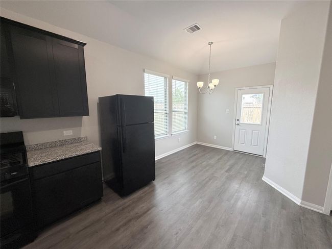 14501 SUGAR PINES DR - Eating area in Kitchen with all black appliances, refrigerator included | Image 20