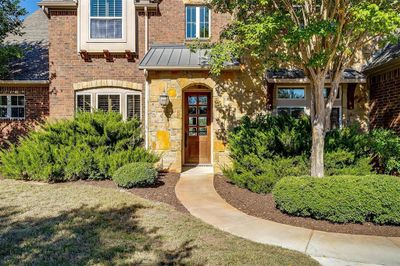 Walk up to a beautiful wooden front door with glass panes. | Image 3