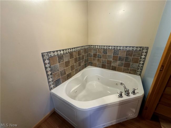 Bathroom featuring a washtub and hardwood / wood-style flooring | Image 14