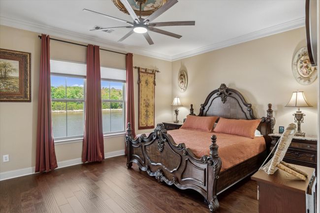 Bedroom featuring ornamental molding, wood finished floors, baseboards, and a ceiling fan | Image 10