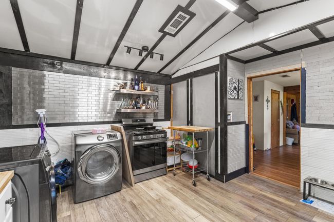 Washroom with washer / clothes dryer and wood finished floors | Image 11