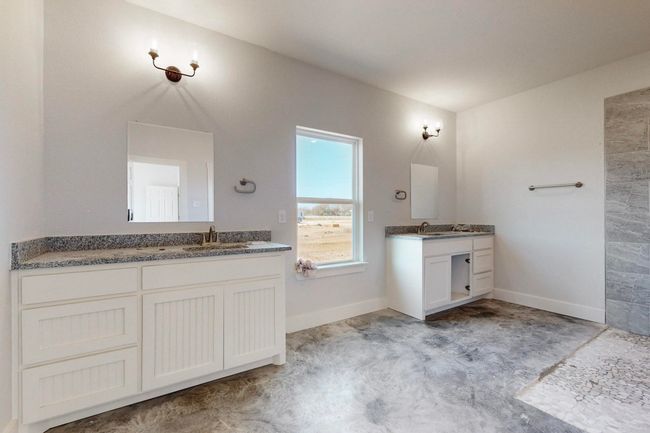 Bathroom with two vanities, a sink, and baseboards | Image 22