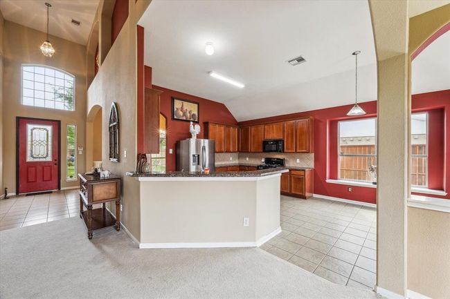 Arched room openings and windows are nice accents in the living area | Image 6
