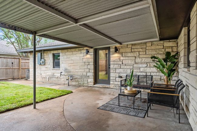 Expansive covered space between the garage and back door, to keep you from the elements or just relax outside | Image 24