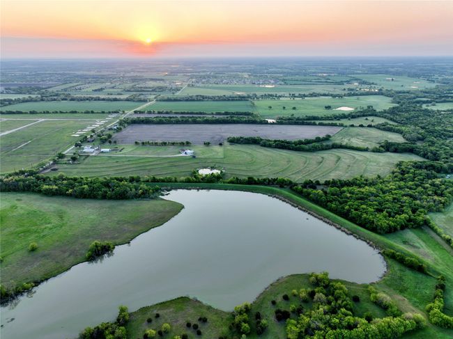 Aerial view of property's location with a nearby body of water and rural landscape | Image 5