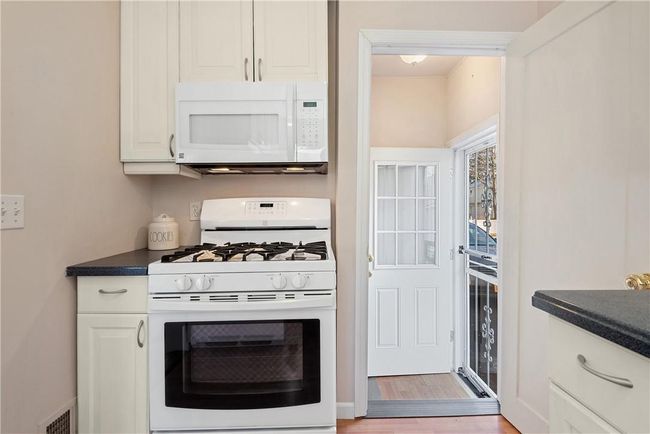 Another view of the kitchen showing the side door leading to the driveway | Image 7