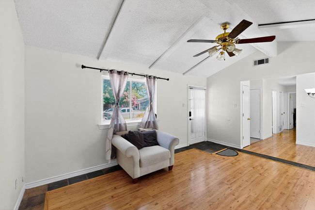 Entryway featuring a textured ceiling, wood finished floors, and ceiling fan | Image 20