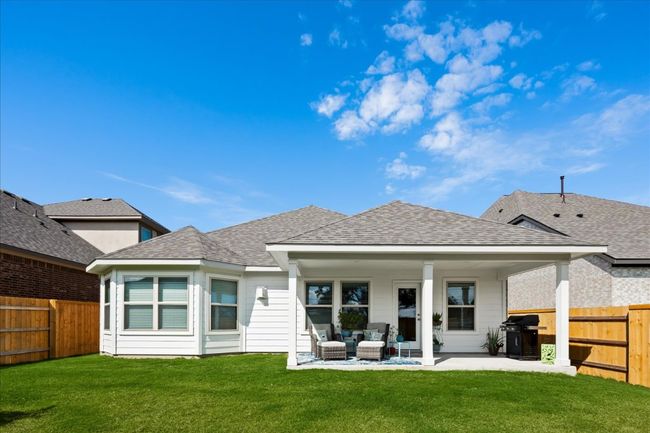 Back of house with a patio area, a lawn, a shingled roof, and a fenced backyard | Image 29