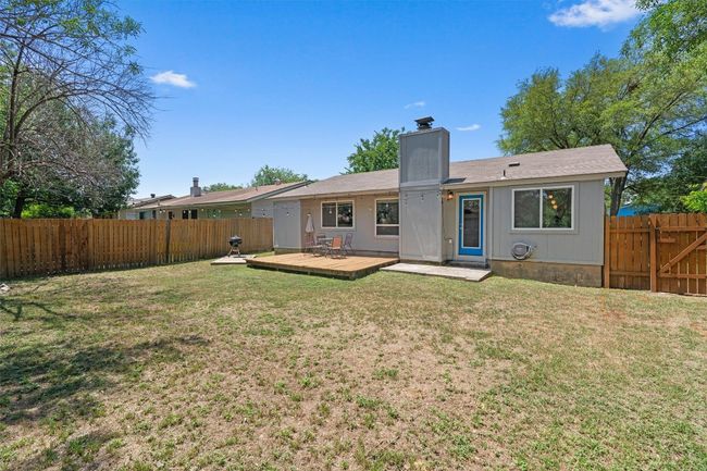 Back of house featuring a chimney and a wooden deck | Image 29